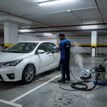 ScrubUp technician cleaning a parked car