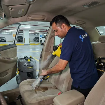 Technician extracting stains from car seats