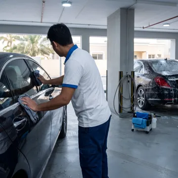 Technician detailing a car exterior