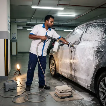 Mobile technician cleaning a car at a parking spot