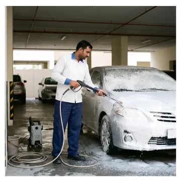 Mobile technician applying snow foam to a car