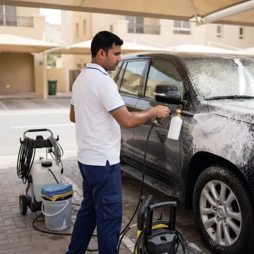 Mobile car wash technician cleaning a Toyota Land Cruiser