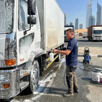 Mobile truck wash technician cleaning a parked vehicle