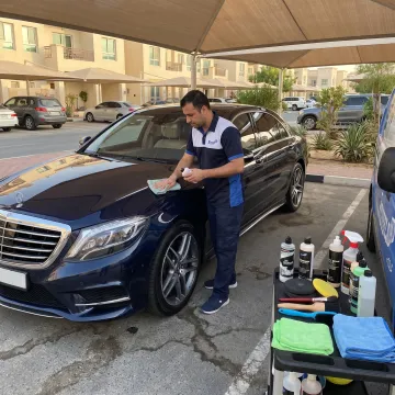 Mobile technician detailing a car in Dubai
