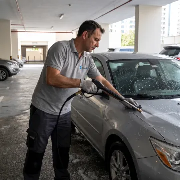 Technician detailing a car at a Dubai residence