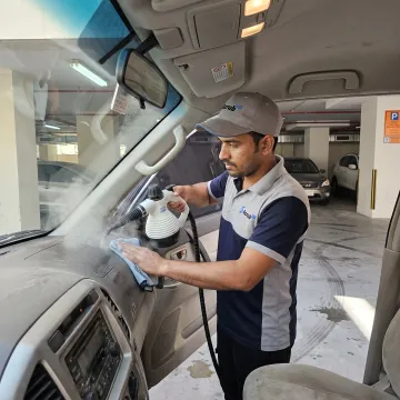 Mobile technician detailing a car interior