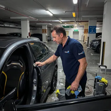 Mobile technician detailing a parked car