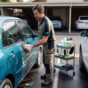 Mobile technician detailing a car at a parking spot