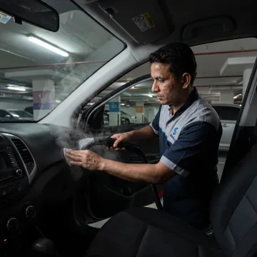 Mobile technician detailing a car interior