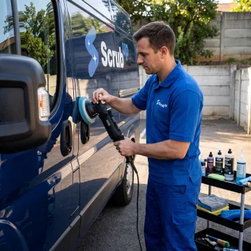 Mobile detailing technician polishing a car exterior