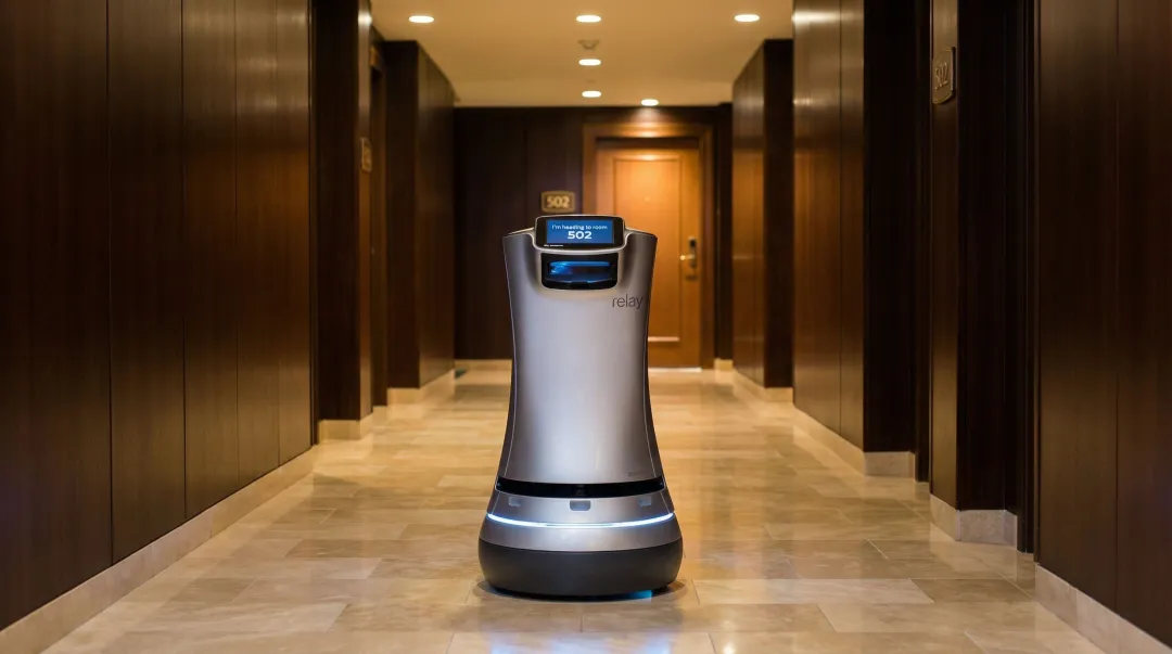 Hotel lobby delivery robot autonomously navigating hallway toward guest room
