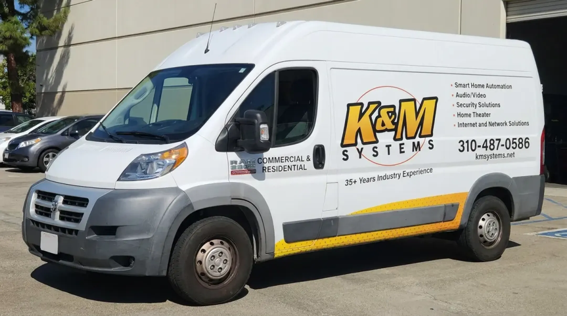 White work van with partial vinyl wrap showing logo and contact information