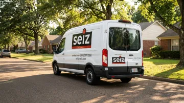 Branded HVAC service van with full fleet wrap driving suburban neighborhood street