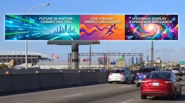 Modern LED digital billboard display showing bright rotating advertisements along highway