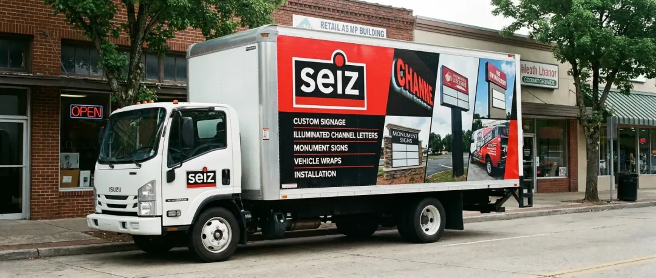 Retail company box truck with rolling billboard wrap