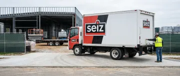 Construction company box truck with branded vehicle wrap