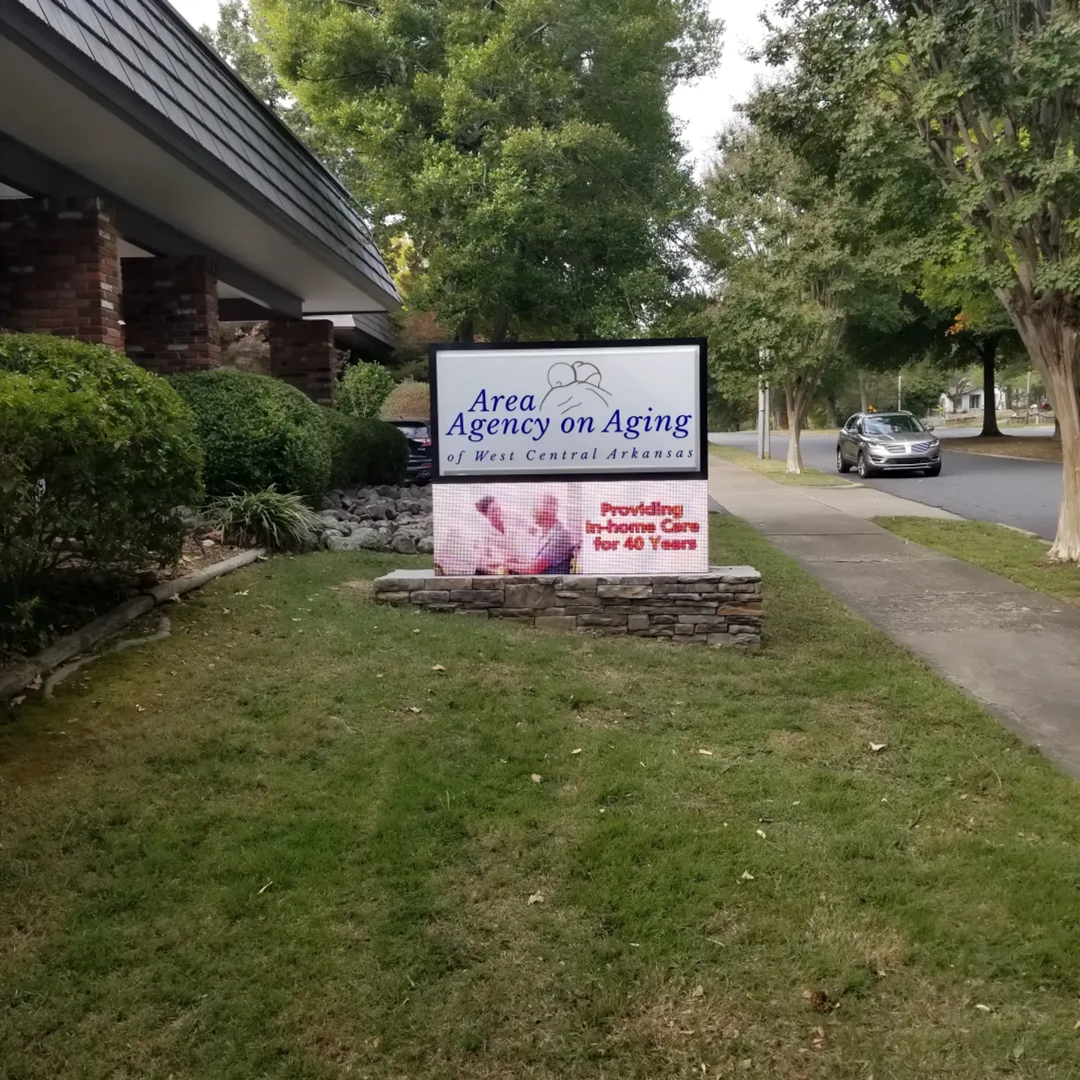 A professionally repaired monument sign standing proudly in front of a commercial building.