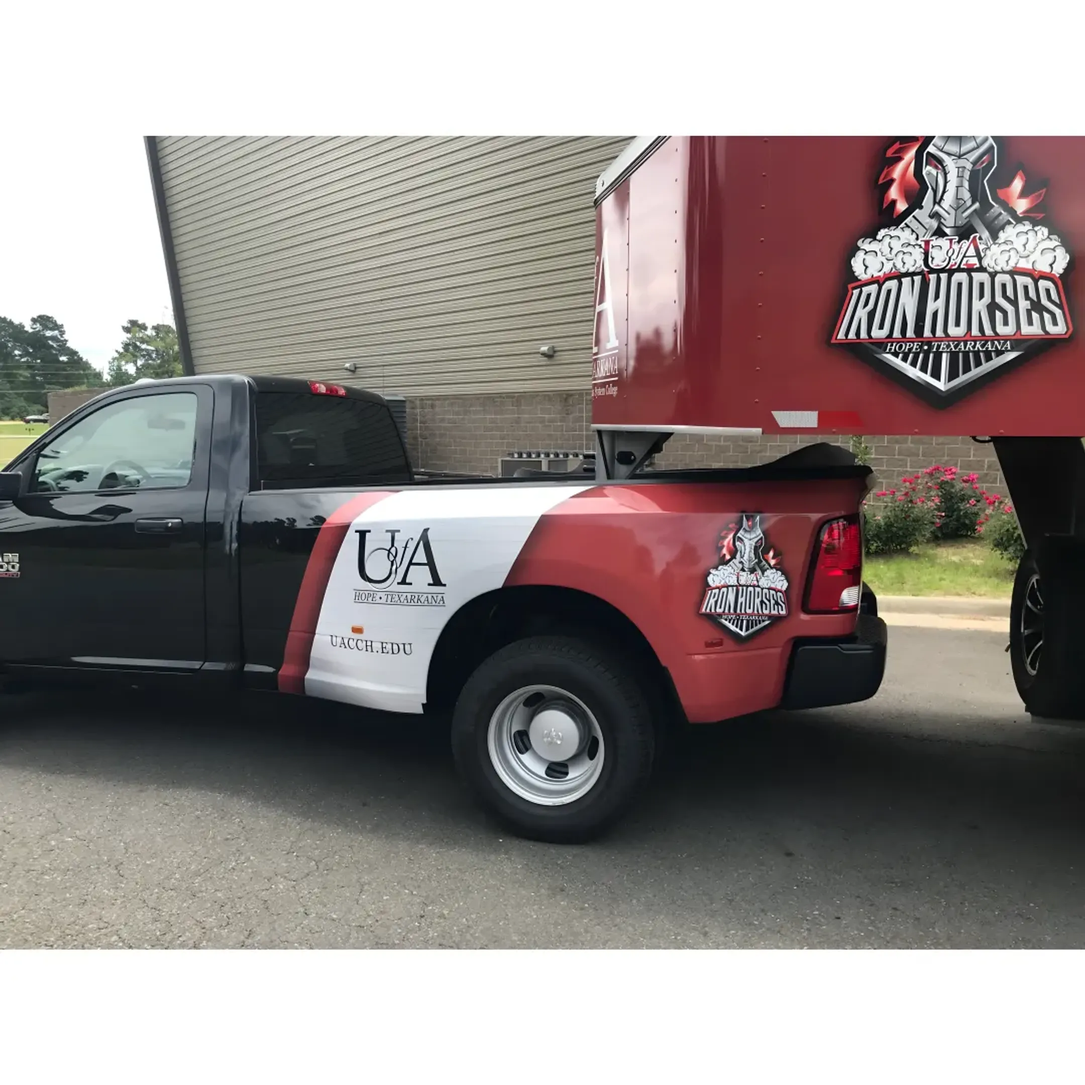 A technician carefully applying a vinyl wrap to a company truck.