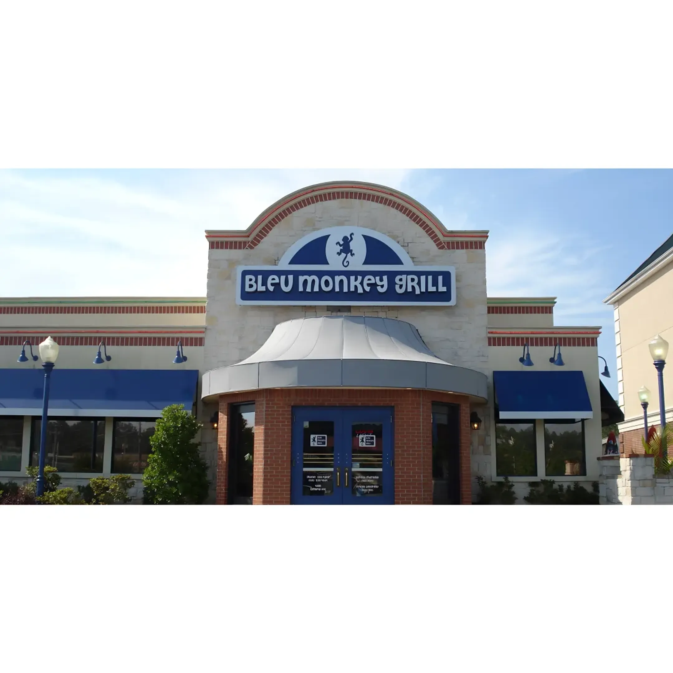 Technicians installing a large pylon sign with a crane.