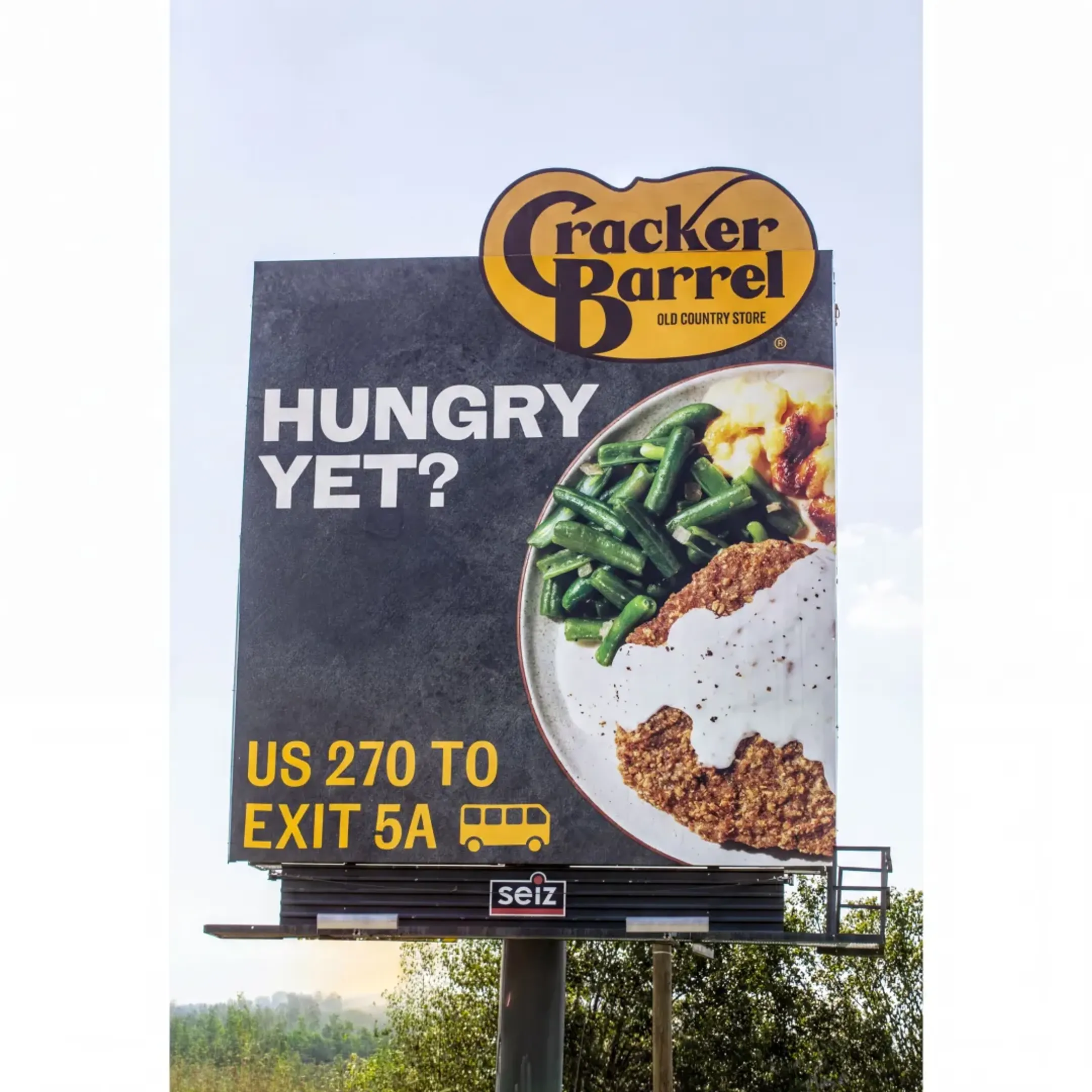 A team of designers collaborating on a new billboard advertisement creative in an office.