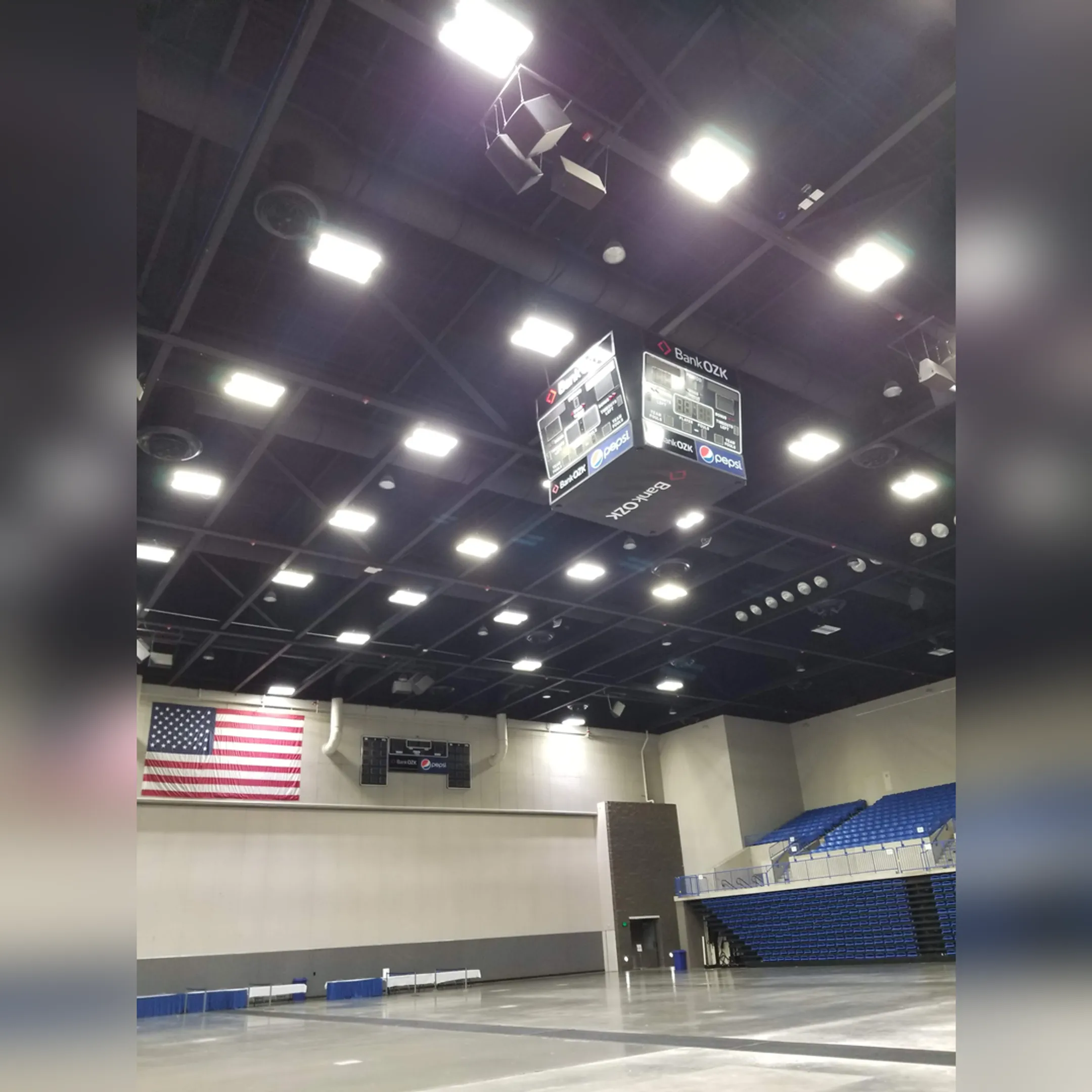 Technicians working on the wiring of a large school scoreboard.