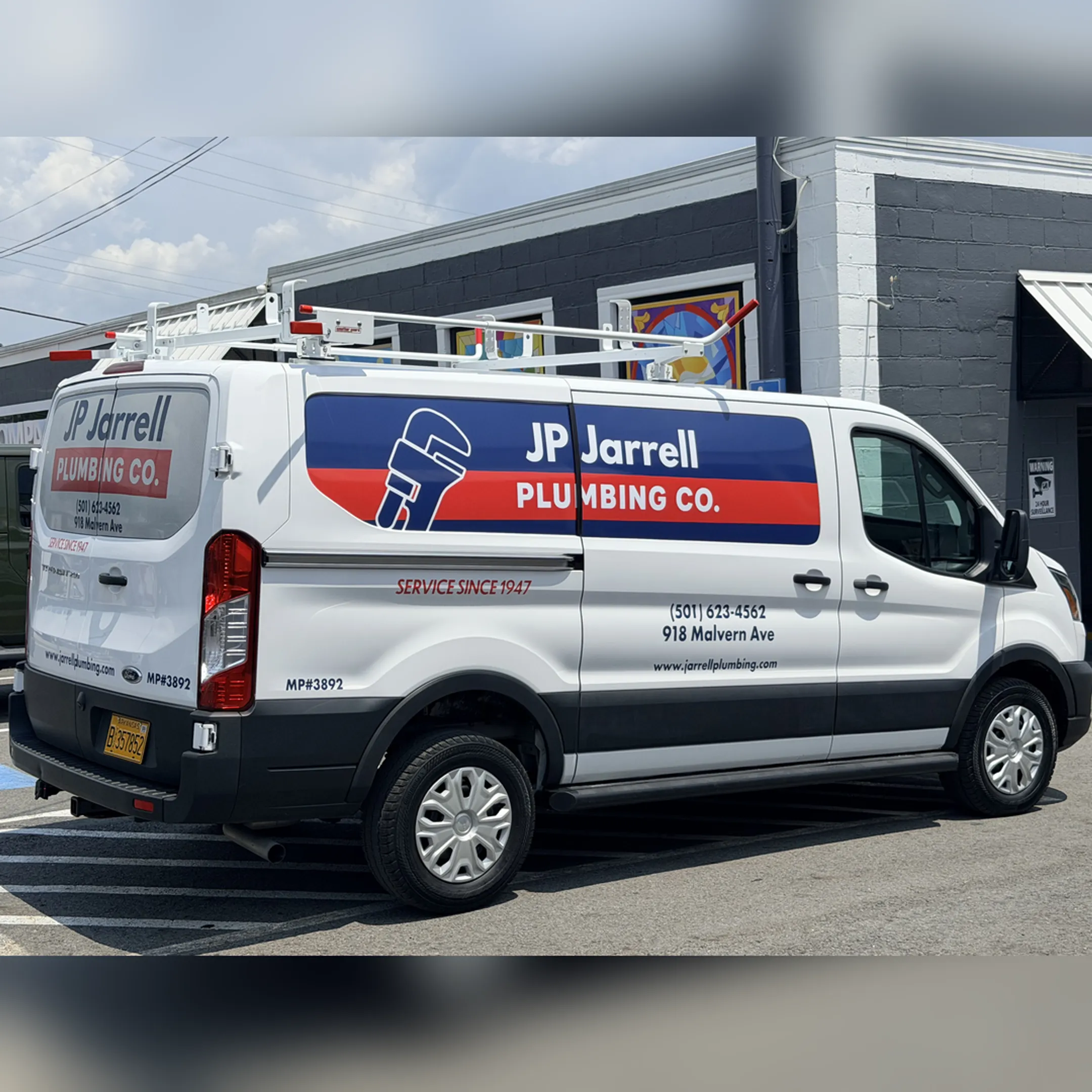 Professional applying a custom vehicle wrap to a white commercial van.