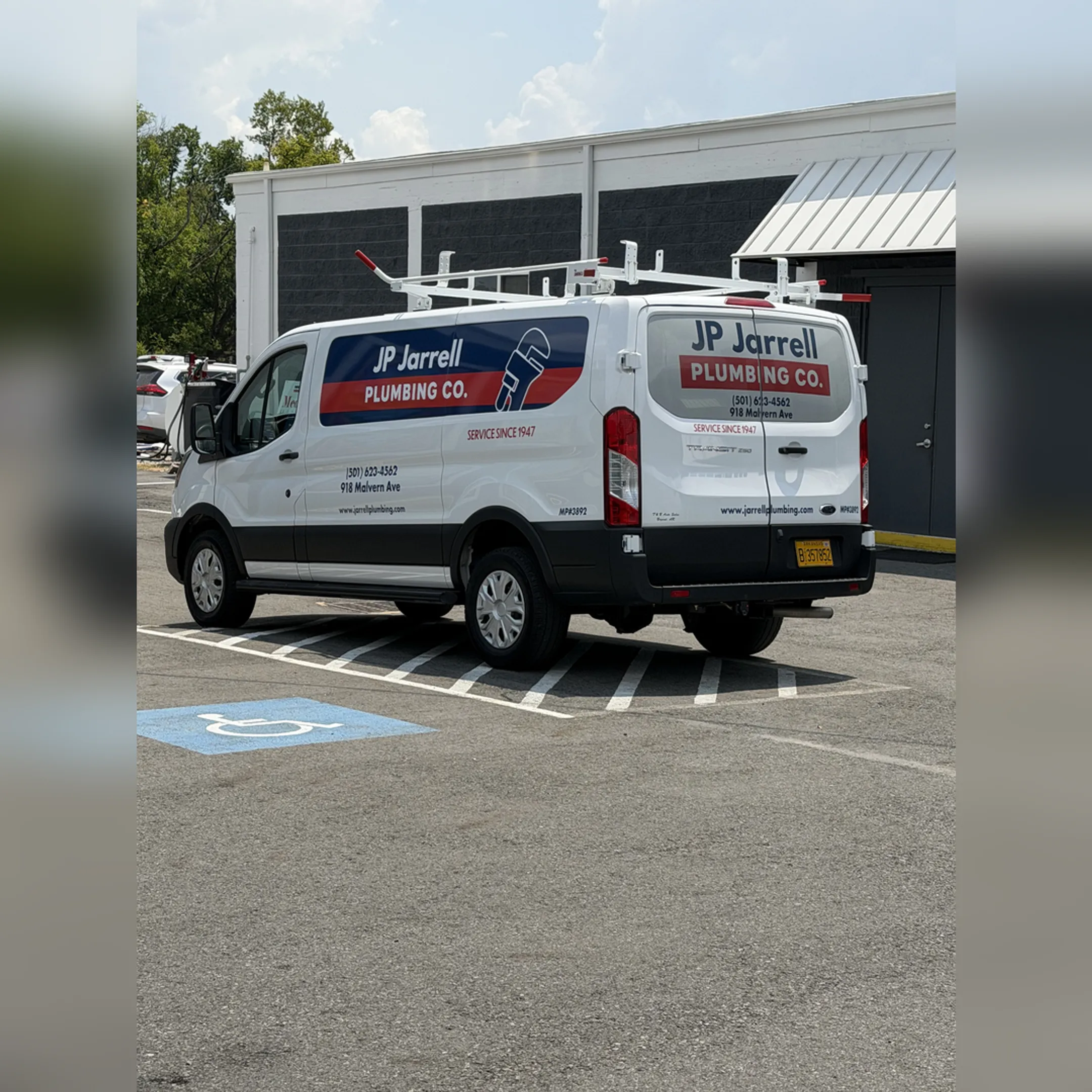 Technician installing a custom vinyl graphic on a truck.