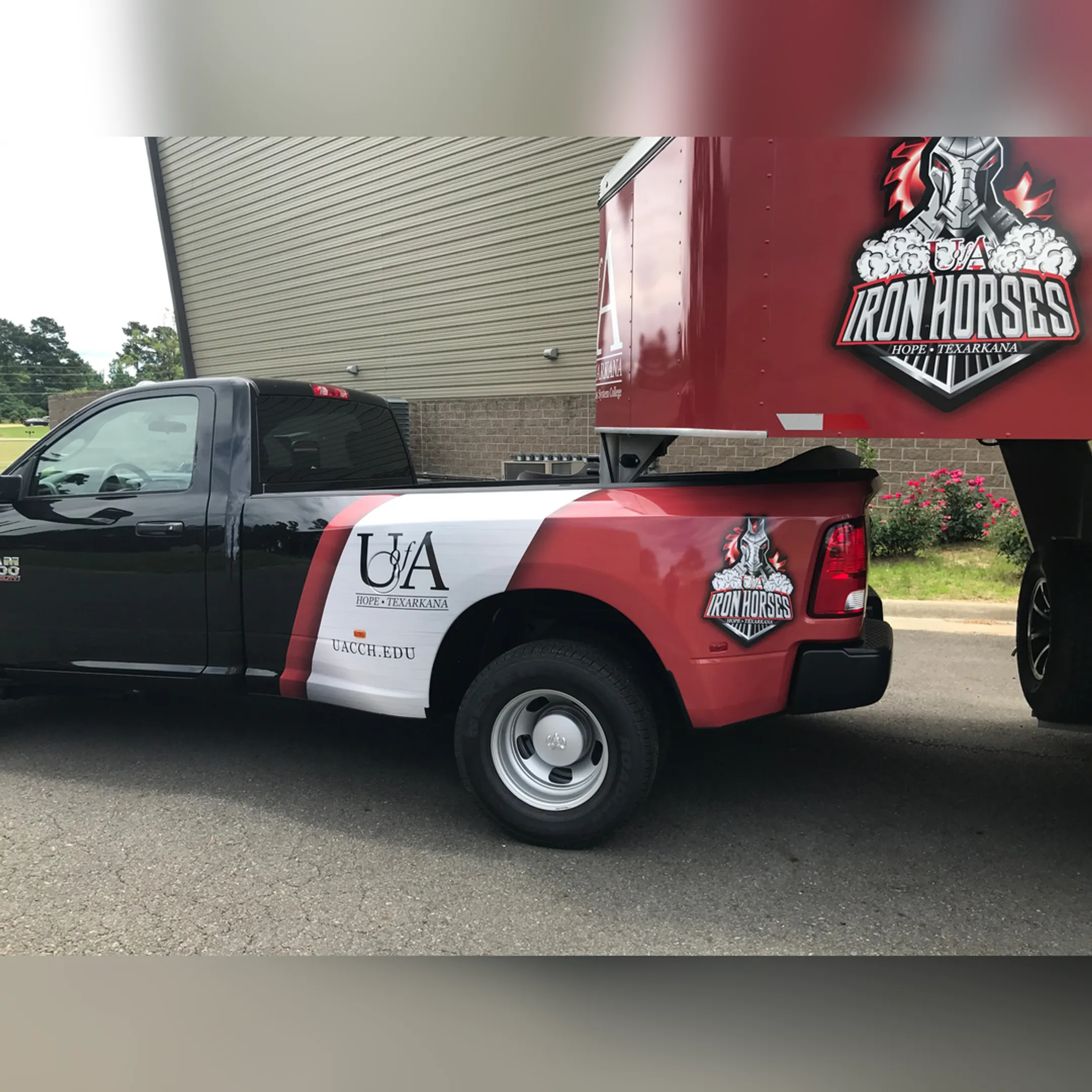 A technician carefully applying a custom vinyl wrap to the side of a food truck.