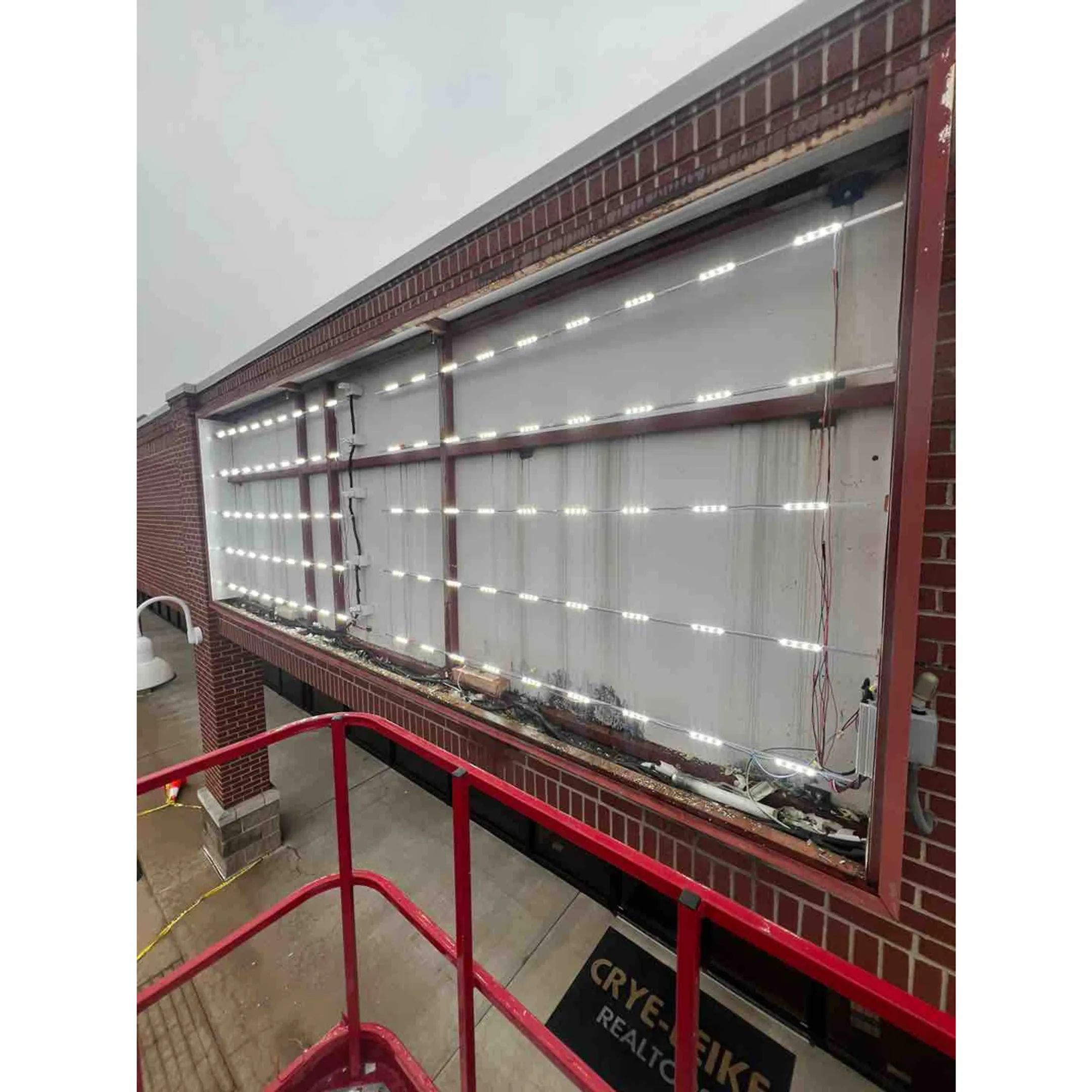 Technician testing emergency exit lighting