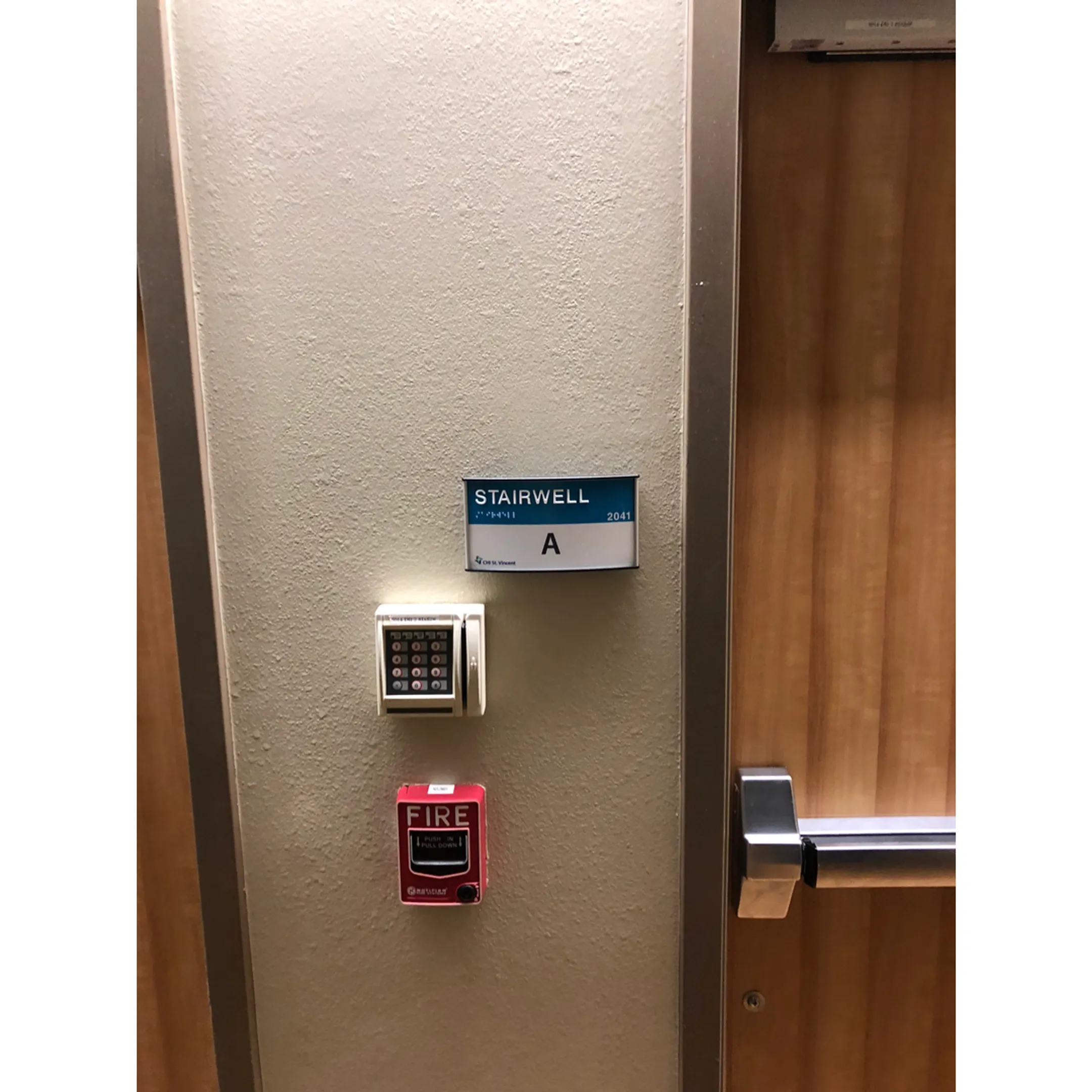 Technician repairing an illuminated emergency exit sign