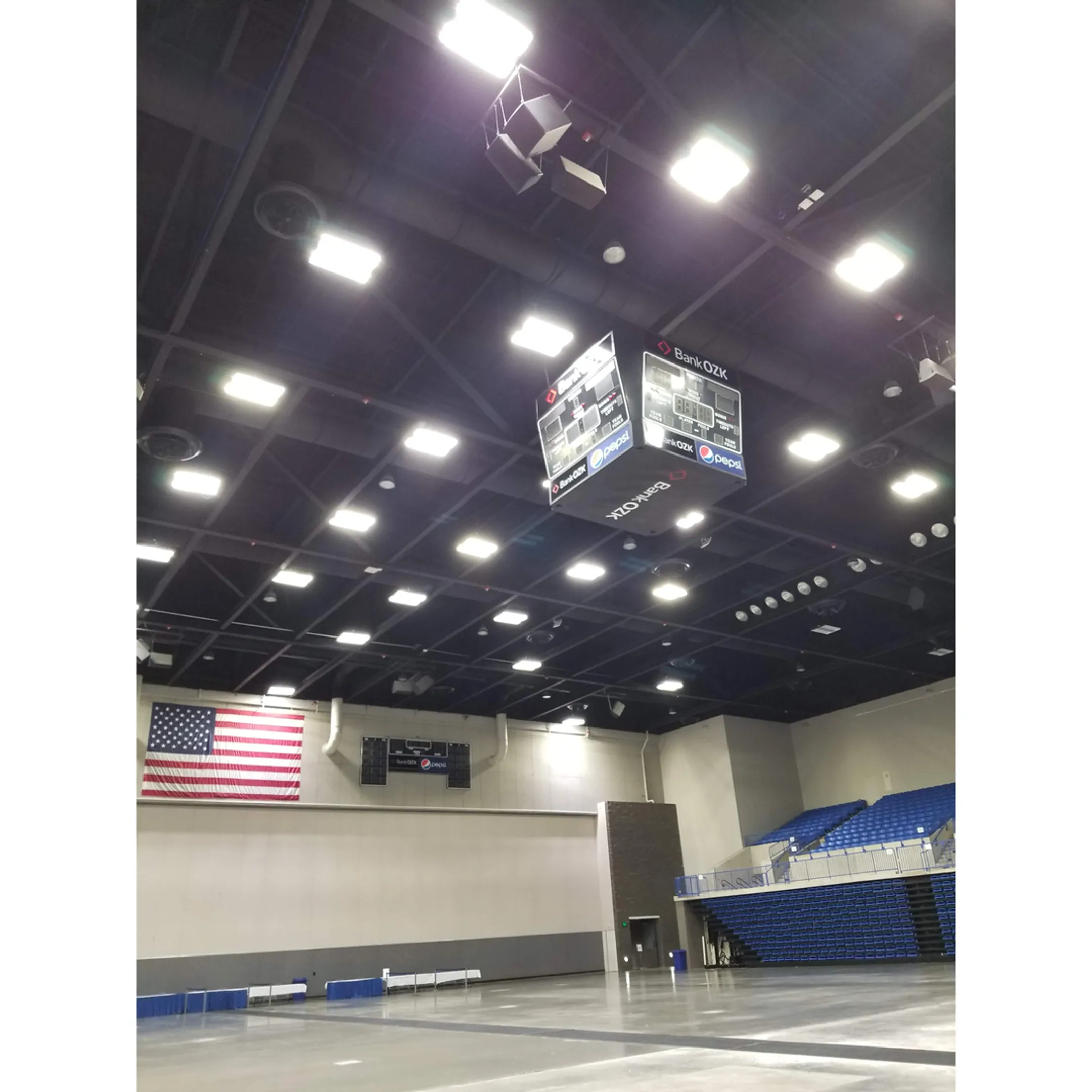 Technicians working on the wiring of a large school scoreboard.