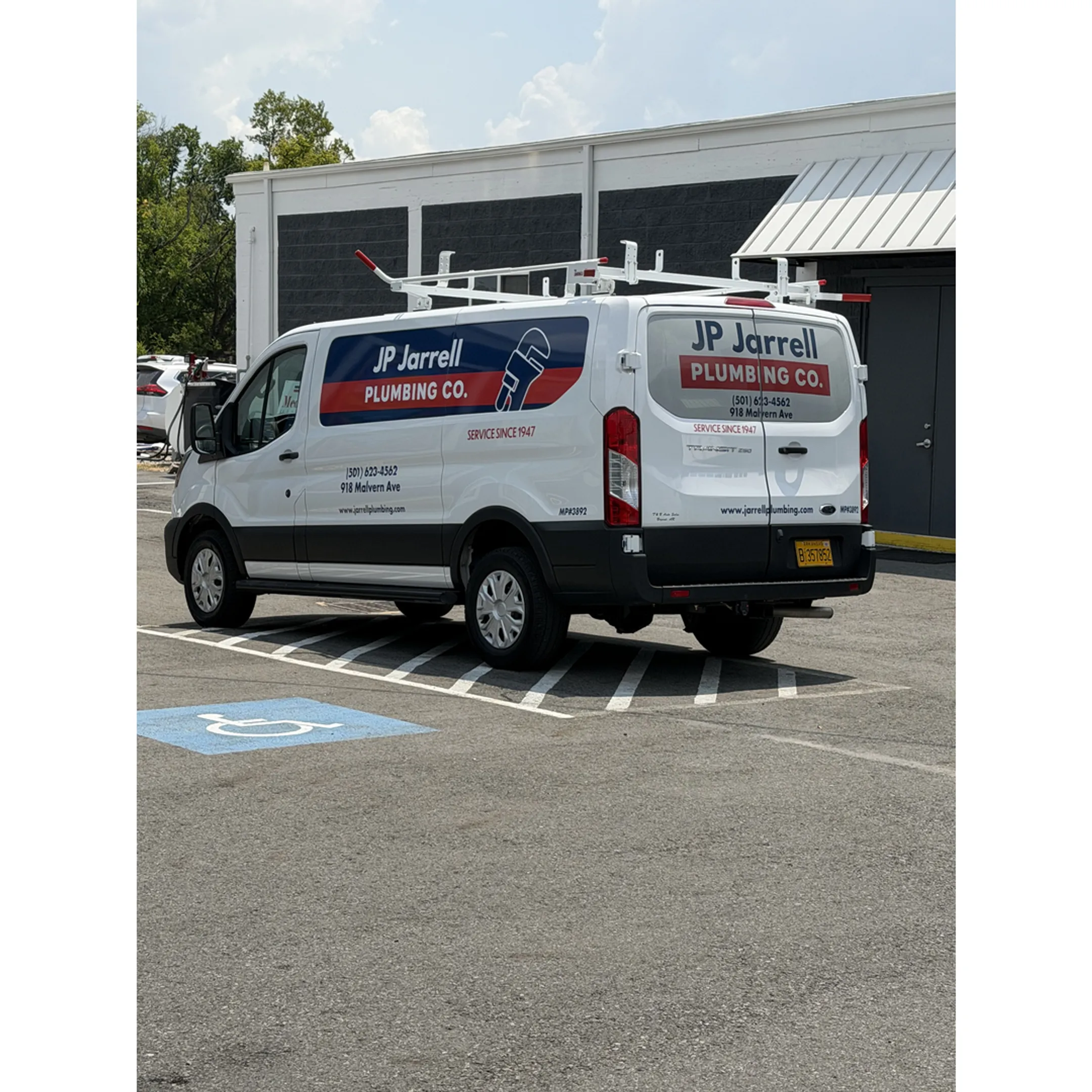 Technician installing a custom vinyl graphic on a truck.
