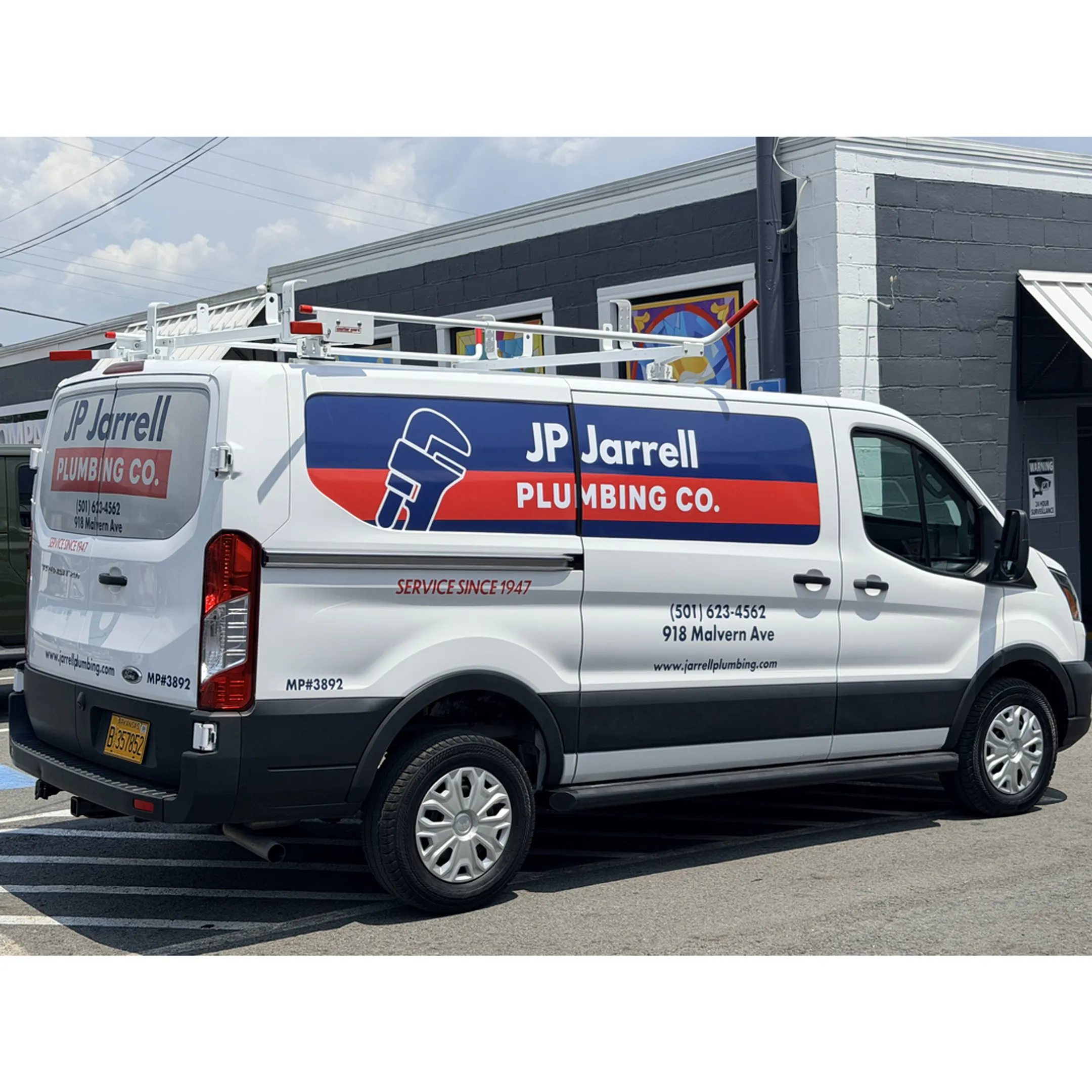 Professional applying a custom vehicle wrap to a white commercial van.