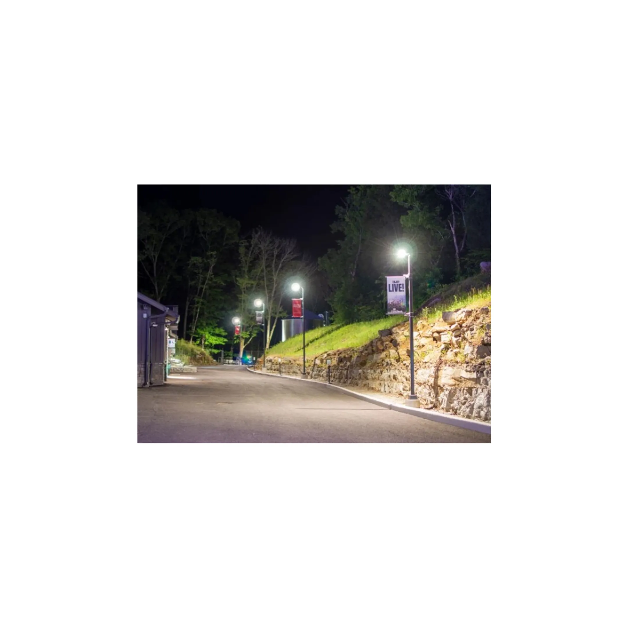 Brightly lit commercial parking lot at dusk after new LED light installation.