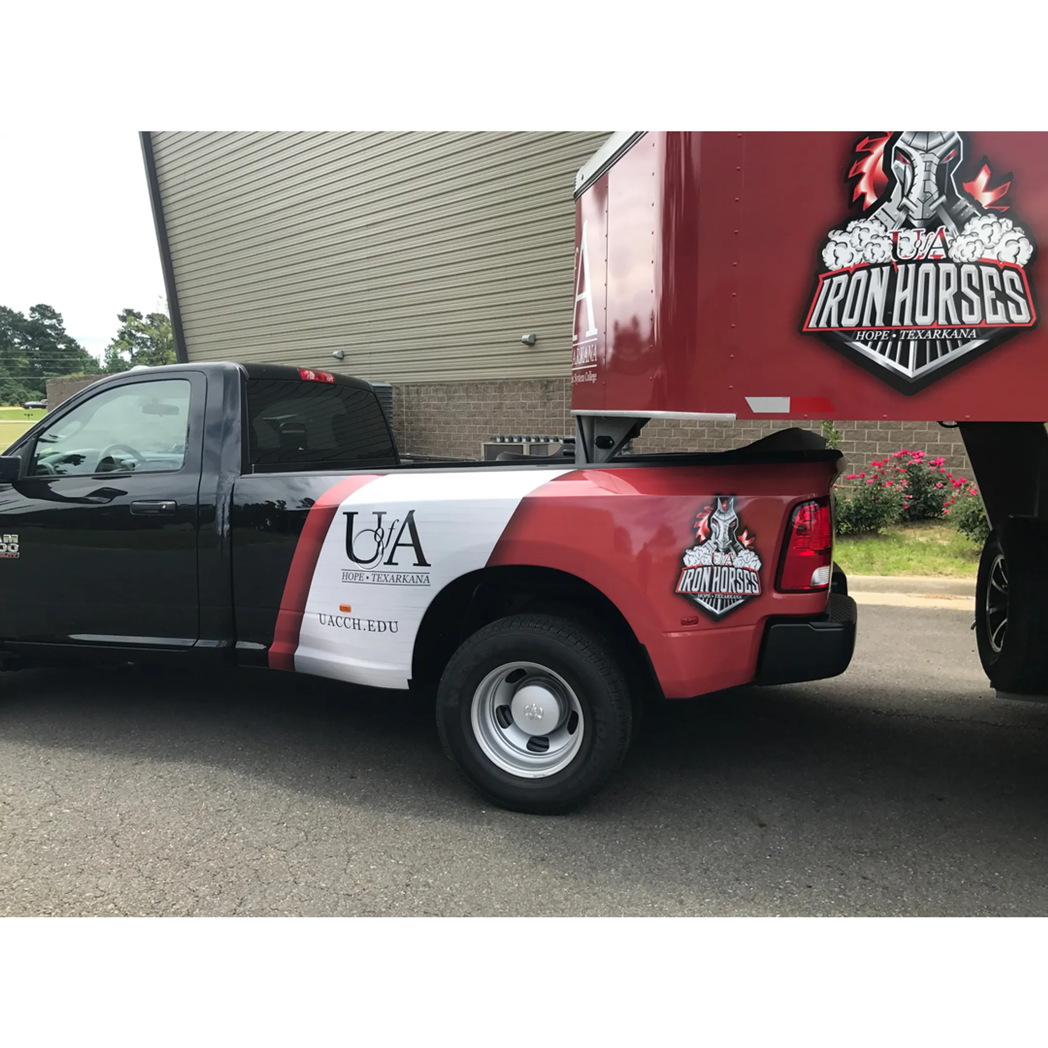 A technician carefully applying a custom vinyl wrap to the side of a food truck.