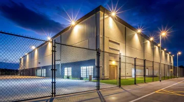 Industrial self-storage facility exterior showing paving fencing and security lighting