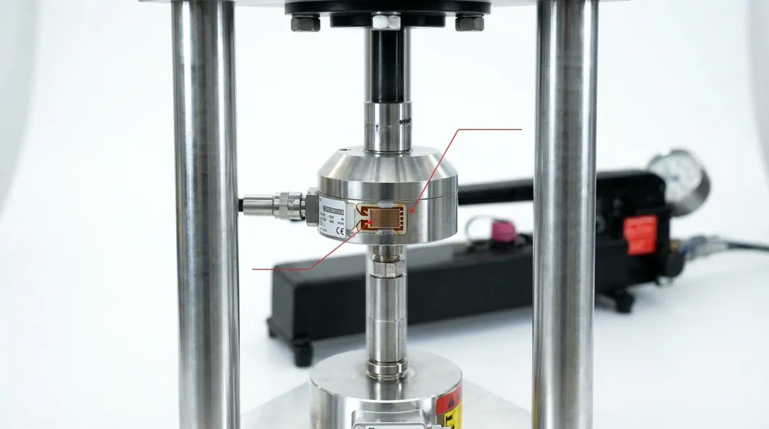 Industrial strain gauge load cell installed in structural fatigue testing rig