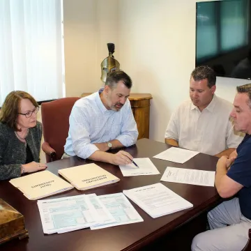 Professional estate planning consultation with financial documents and legal instruments on a conference table