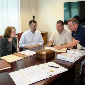 Professional financial advisors reviewing estate planning documents with clients