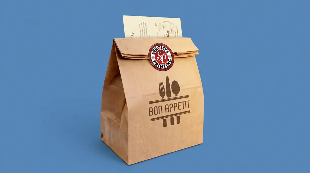 Branded restaurant takeout bag with logo sticker and packaging insert visible