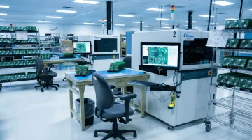 Automotive PCB assembly on manufacturing line undergoing quality inspection process