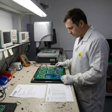Engineer inspecting fabricated PCB panels