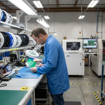 Engineer reviewing PCB assembly quality