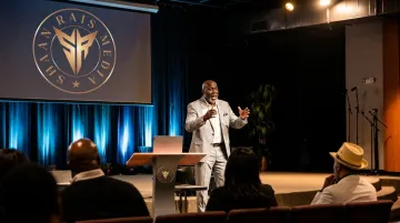 Keynote speaker presenting Positioning Creates Opportunity talk to engaged audience