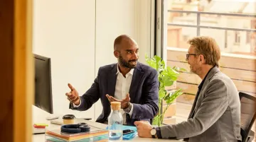 Business leader coaching team member one-on-one professional development meeting