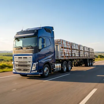 A full truckload freight truck loaded with palletized cargo on a highway