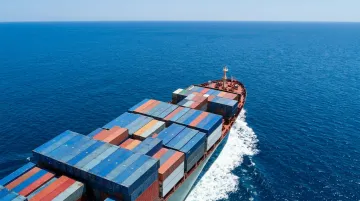 Cargo container ship loaded with shipping containers sailing international sea lane