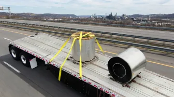 Flatbed truck hauling steel coils on Pennsylvania industrial highway
