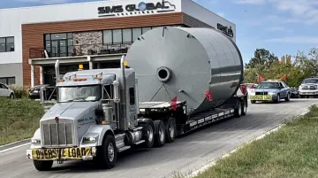 Heavy-haul trailer transporting oversized rigging equipment with GPS tracking