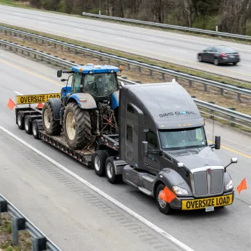 Heavy haul trailer transporting agricultural equipment